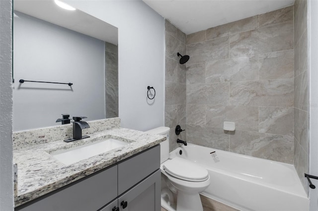 bathroom with wood finished floors, vanity, toilet, and shower / bathtub combination