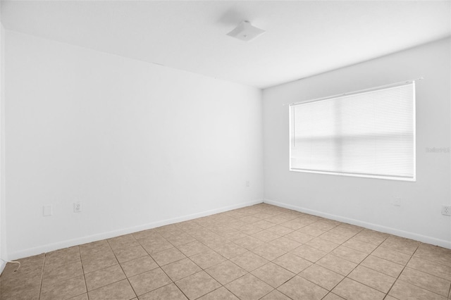 spare room with baseboards