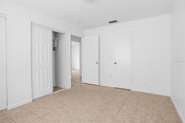 unfurnished bedroom with visible vents and baseboards