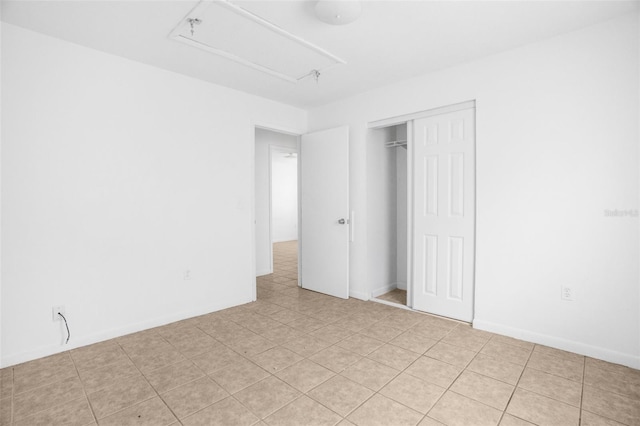 unfurnished bedroom with a closet and baseboards