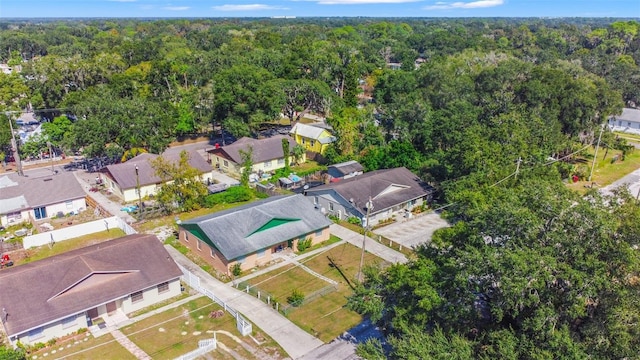 drone / aerial view with a residential view and a view of trees