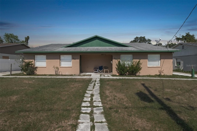 single story home featuring a front yard, fence, and stucco siding