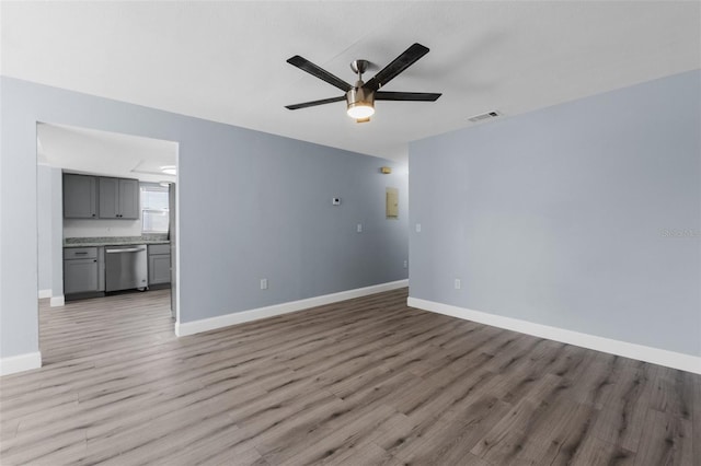 unfurnished living room featuring visible vents, ceiling fan, light wood-style flooring, and baseboards