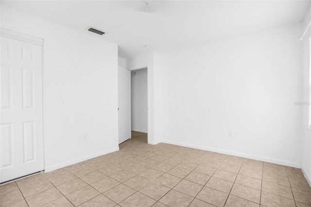 spare room featuring visible vents and baseboards