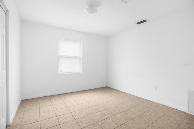 unfurnished room featuring visible vents and baseboards