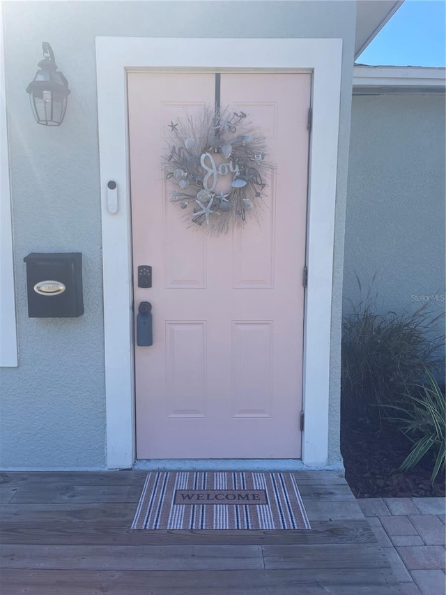 property entrance featuring stucco siding