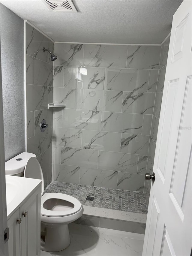 full bathroom with visible vents, marble finish floor, a shower stall, and toilet