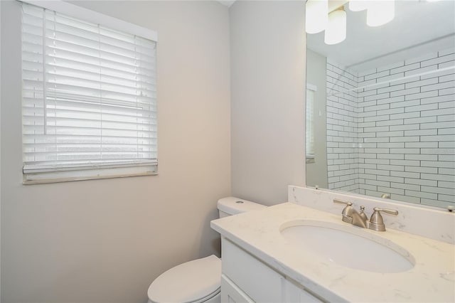 bathroom featuring toilet and vanity