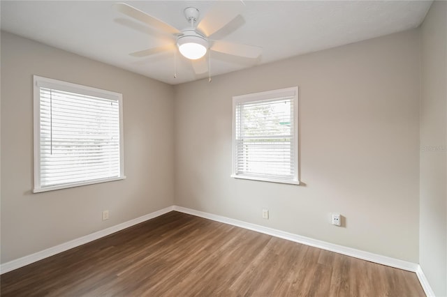 spare room with wood finished floors, baseboards, and ceiling fan