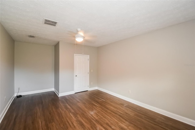 unfurnished room featuring visible vents, ceiling fan, baseboards, wood finished floors, and a textured ceiling