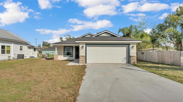 view of front of home featuring a garage, central AC unit, concrete driveway, fence, and a front lawn