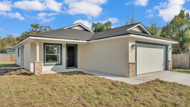 ranch-style home featuring stone siding, stucco siding, an attached garage, fence, and a front yard