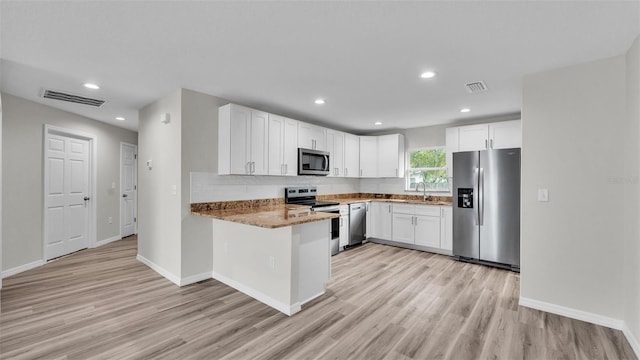 kitchen with stainless steel appliances, visible vents, and white cabinetry