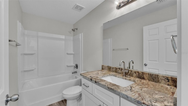 bathroom with toilet, washtub / shower combination, visible vents, and vanity