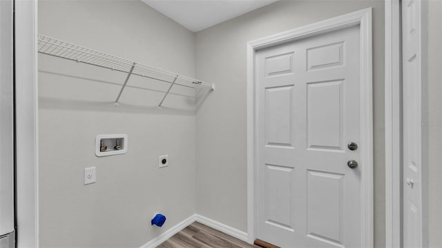 laundry room with washer hookup, electric dryer hookup, wood finished floors, laundry area, and baseboards