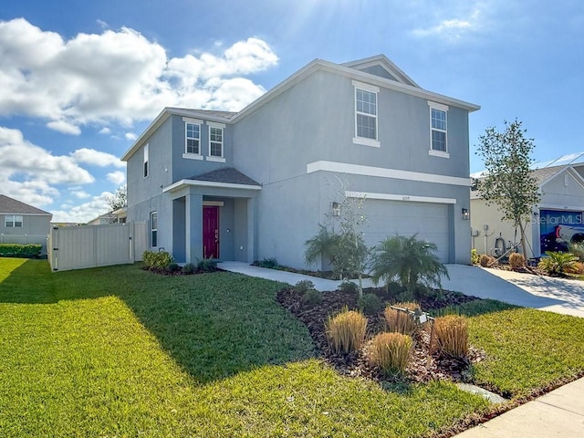 traditional home with stucco siding, fence, a garage, driveway, and a front lawn