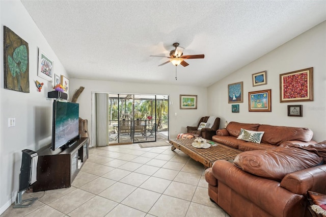 living room with lofted ceiling, ceiling fan, a textured ceiling, and light tile patterned floors