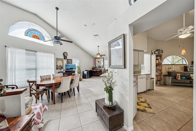 dining area with ceiling fan, light tile patterned flooring, and a healthy amount of sunlight