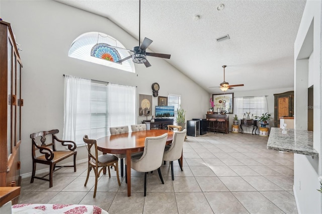 dining area with light tile patterned floors, visible vents, and a ceiling fan