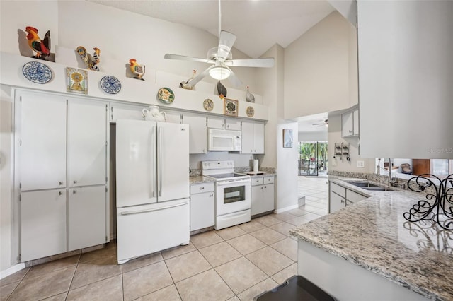 kitchen with light tile patterned floors, ceiling fan, white appliances, and a sink