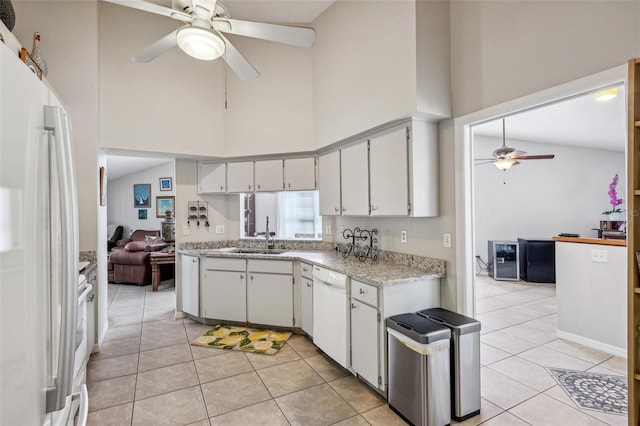 kitchen featuring high vaulted ceiling, white appliances, light tile patterned flooring, and a sink