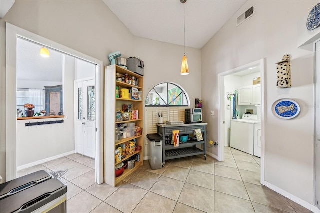 interior space featuring independent washer and dryer, baseboards, visible vents, and light tile patterned flooring