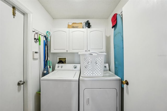 laundry area featuring separate washer and dryer and cabinet space