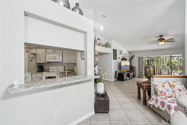 living room featuring lofted ceiling, ceiling fan, a textured ceiling, light tile patterned flooring, and baseboards