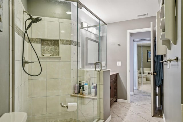 full bathroom featuring a stall shower, tile patterned flooring, visible vents, and baseboards