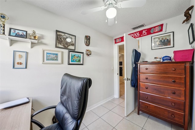 home office with a ceiling fan, visible vents, a textured ceiling, and light tile patterned flooring