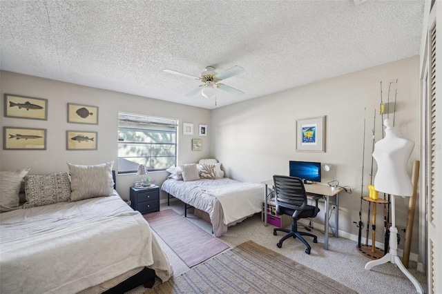 bedroom with a textured ceiling, carpet flooring, a ceiling fan, and baseboards