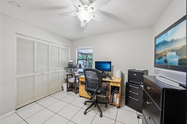 office space featuring a ceiling fan, a textured ceiling, and light tile patterned floors