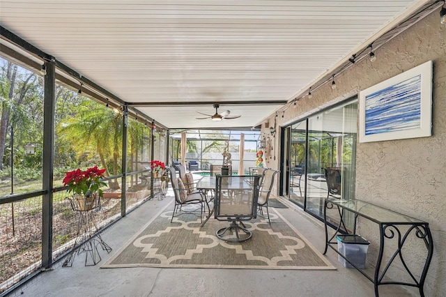 unfurnished sunroom with ceiling fan