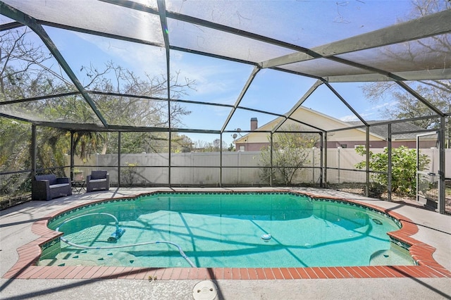 view of pool with a patio area, a fenced backyard, glass enclosure, and a fenced in pool