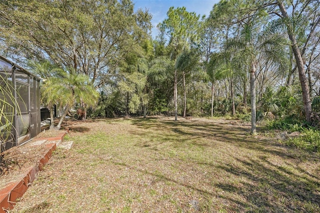 view of yard featuring a lanai