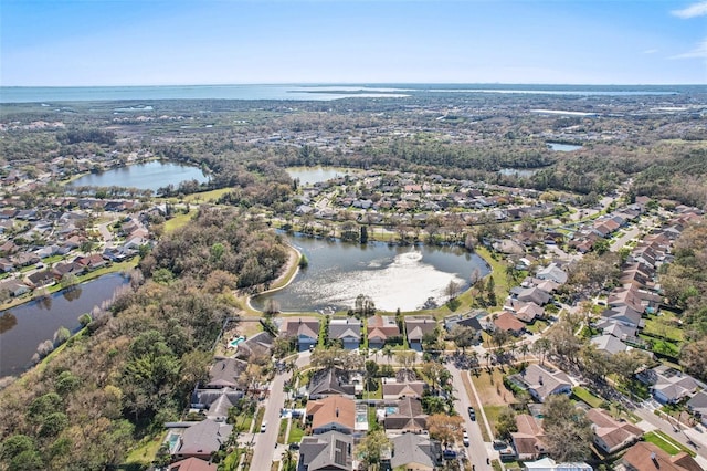 drone / aerial view featuring a water view and a residential view