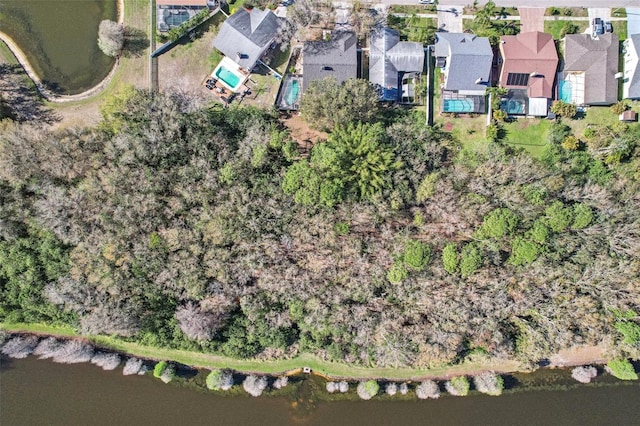 drone / aerial view featuring a water view and a residential view