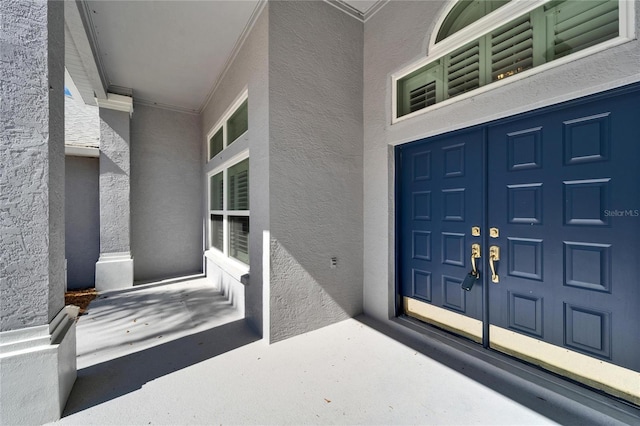 property entrance with stucco siding