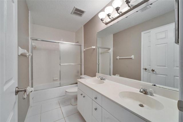 full bathroom with a textured ceiling, a sink, visible vents, and tile patterned floors