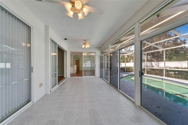 unfurnished sunroom with ceiling fan and visible vents