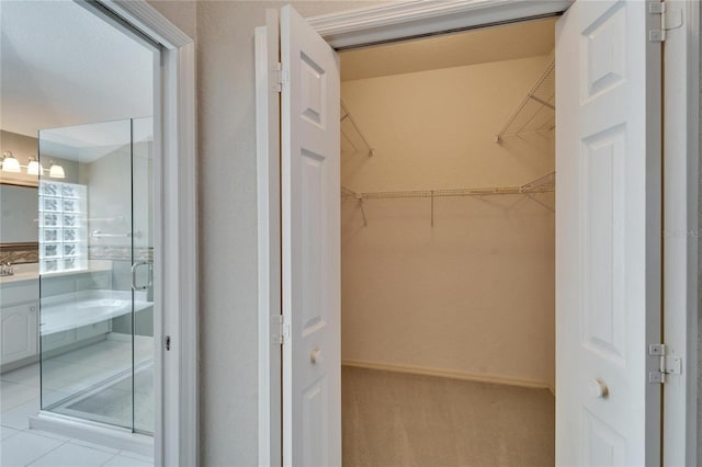 spacious closet with tile patterned flooring