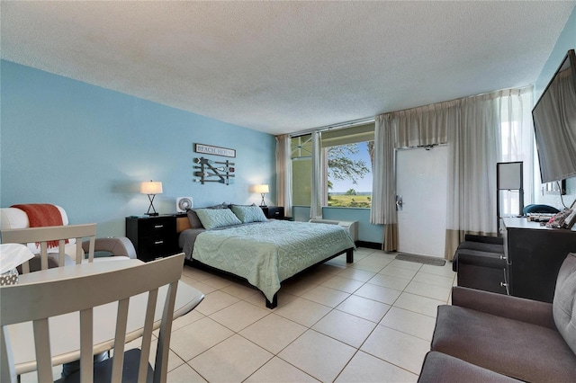 bedroom featuring light tile patterned floors and a textured ceiling