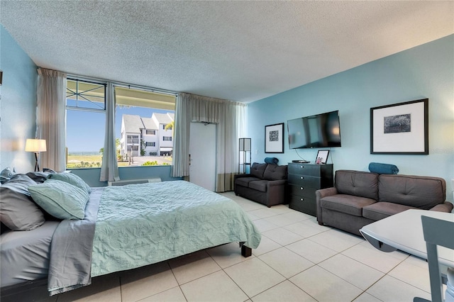 bedroom featuring light tile patterned floors and a textured ceiling