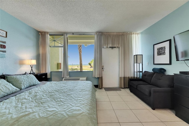 bedroom featuring light tile patterned floors and a textured ceiling