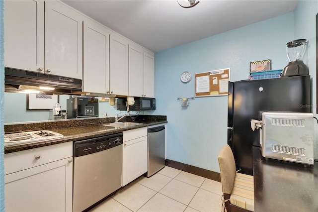 kitchen with light tile patterned floors, dark countertops, a sink, under cabinet range hood, and black appliances