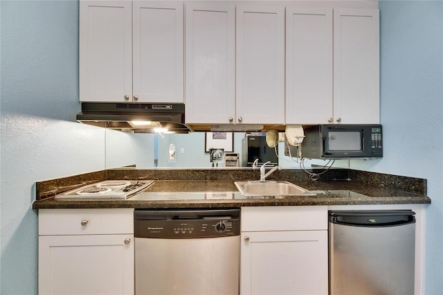 kitchen featuring white cabinetry, a sink, dishwasher, under cabinet range hood, and fridge