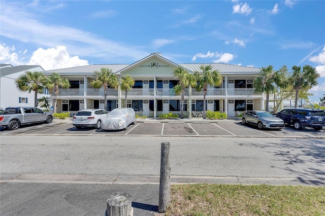 view of building exterior with uncovered parking