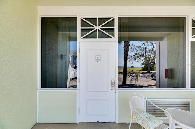 entrance to property featuring stucco siding