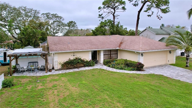 ranch-style home featuring a garage, a gazebo, decorative driveway, stucco siding, and a front lawn