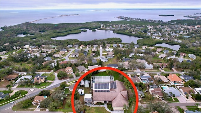 drone / aerial view featuring a water view and a residential view